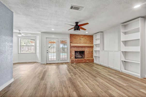 Empty room, Fireplace, Interior, Recessed Lighting, Stone Walls, Wood Texture Flooring