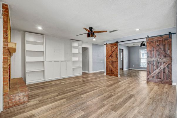 Empty room, Fireplace, Interior, Recessed Lighting, Stone Walls, Wood Texture Flooring
