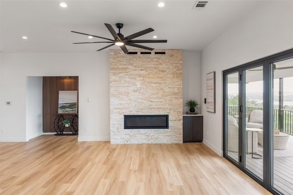 Empty room, Fireplace, Interior, Recessed Lighting, Stone Walls, Wood Texture Flooring