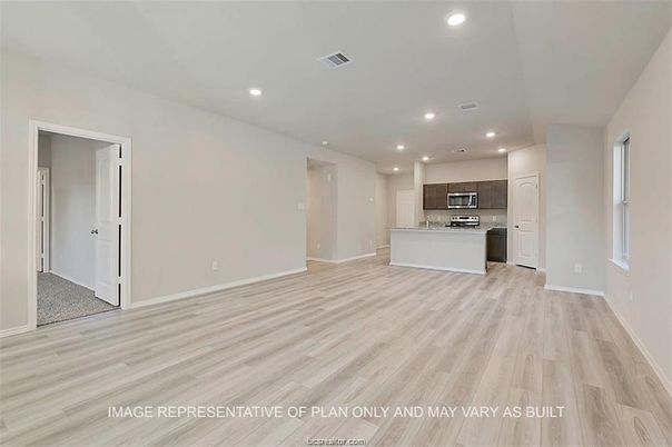 Empty room, Interior, Kitchen, Recessed Lighting, Stainless Steel Appliances, Wood Texture Flooring