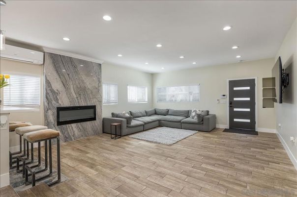 Fireplace, Interior, Living room, Marble Walls, Recessed Lighting, Wood Texture Flooring