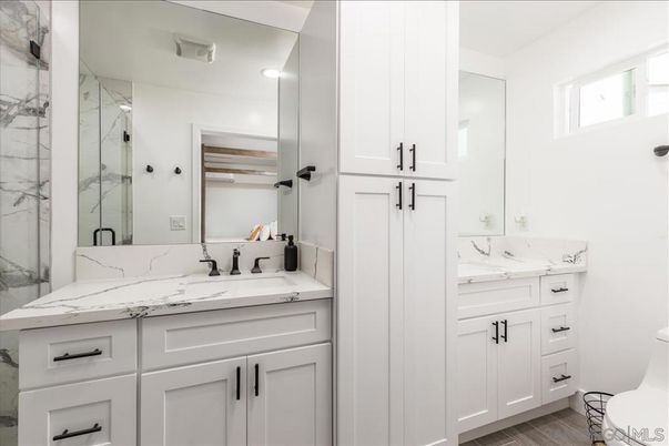 Bathroom, Dual Sink Vanities, Glass Shower, Interior, Marble Walls, Recessed Lighting, Wood Texture Flooring