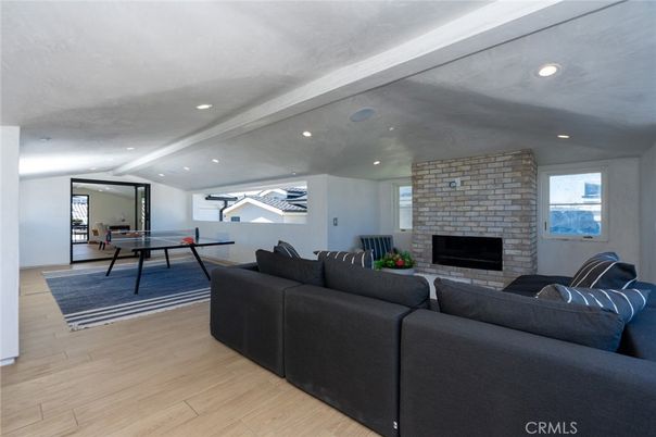 Fireplace, Game Room, Interior, Living room, Recessed Lighting, Stone Walls, Wood Texture Flooring