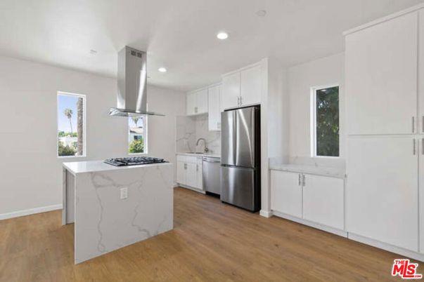 Interior, Kitchen, Marble Walls, Recessed Lighting, Stainless Steel Appliances, Wood Texture Flooring