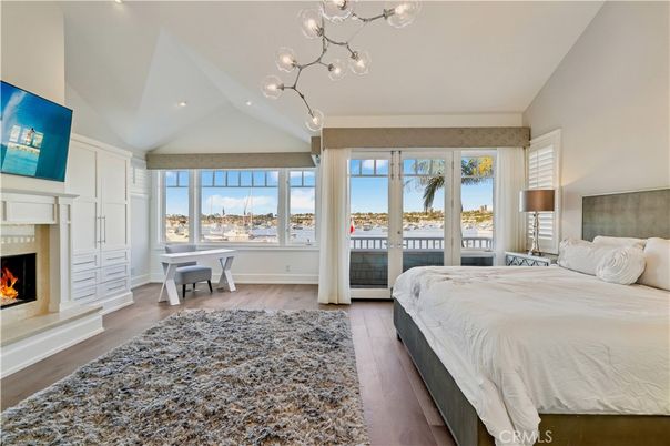 Bedroom, Fireplace, Interior, Pendant Lights, Recessed Lighting, Water, Wood Texture Flooring
