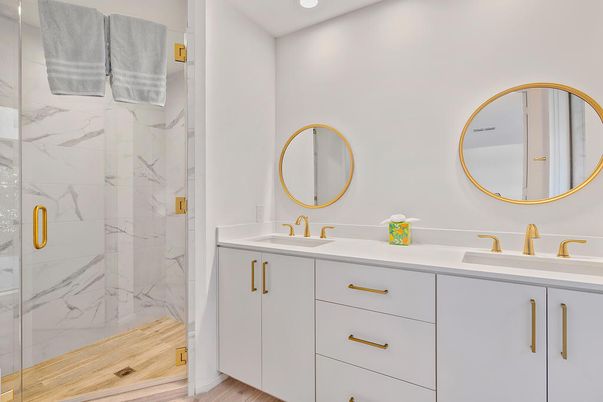 Bathroom, Dual Sink Vanities, Glass Shower, Interior, Marble Walls, Recessed Lighting, Wood Texture Flooring