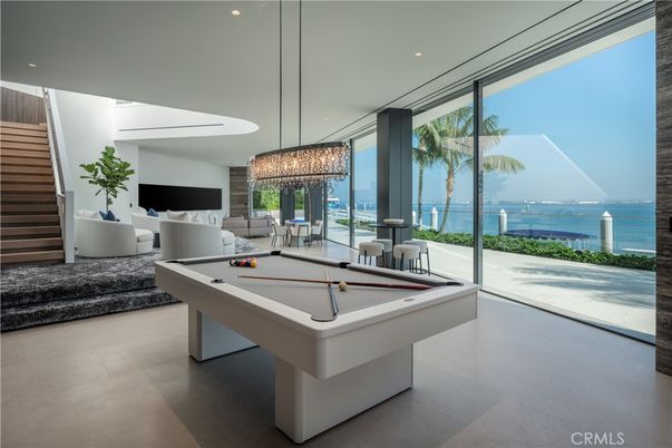 Billiard Table, Chandelier, Fireplace, Game Room, Interior, Living room, Pendant Lights, Recessed Lighting, Water