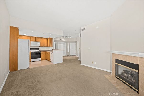 Empty room, Fireplace, Interior, Kitchen, Pendant Lights, Recessed Lighting, Stainless Steel Appliances