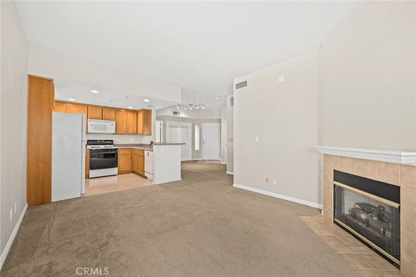 Empty room, Fireplace, Interior, Kitchen, Pendant Lights, Recessed Lighting, Stainless Steel Appliances