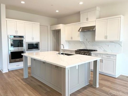 Interior, Kitchen, Marble Walls, Recessed Lighting, Stainless Steel Appliances, Wood Texture Flooring