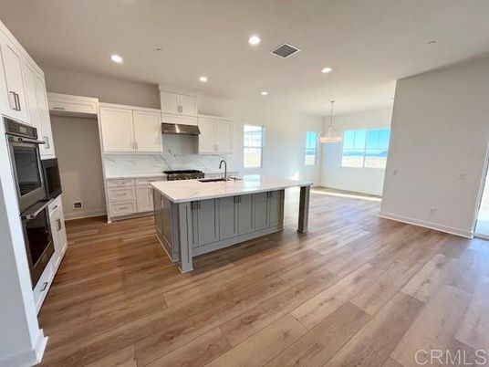 Interior, Kitchen, Marble Walls, Pendant Lights, Recessed Lighting, Stainless Steel Appliances, Wood Texture Flooring