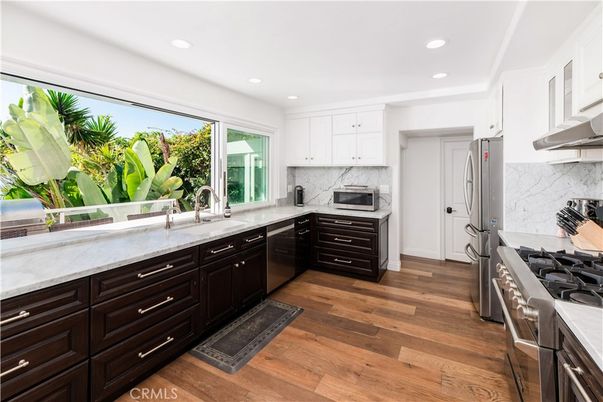 Interior, Kitchen, Marble Walls, Recessed Lighting, Stainless Steel Appliances, Wood Texture Flooring