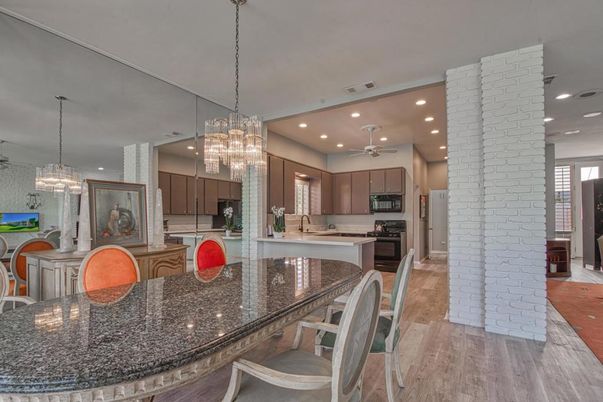 Chandelier, Dining room, Interior, Kitchen, Pendant Lights, Recessed Lighting, Stainless Steel Appliances, Stone Walls, Wood Texture Flooring