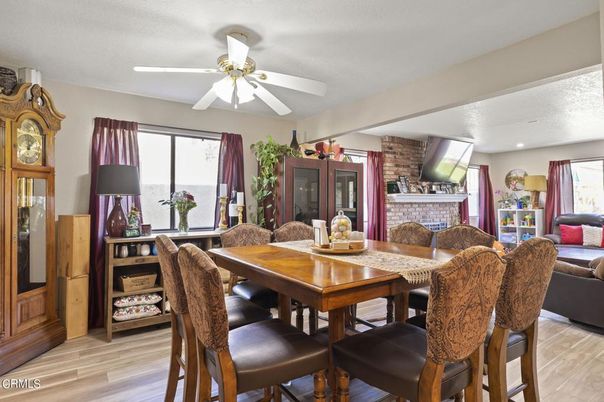 Dining room, Fireplace, Interior, Living room, Recessed Lighting, Stone Walls, Wood Texture Flooring
