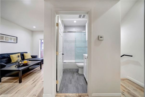 Bathroom, Glass Shower, Interior, Marble Walls, Recessed Lighting, Wood Texture Flooring