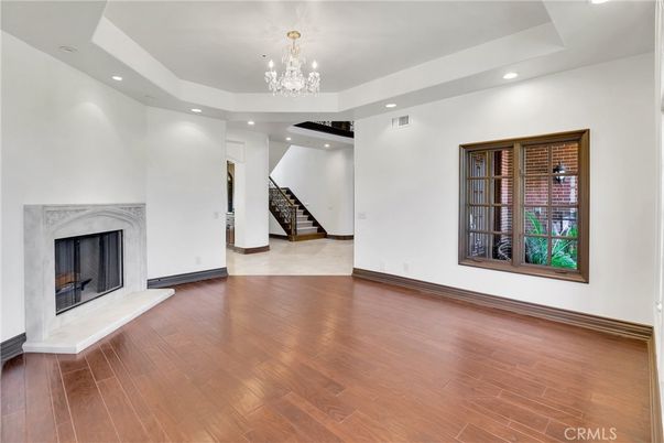 Chandelier, Empty room, Fireplace, Interior, Recessed Lighting, Wood Texture Flooring