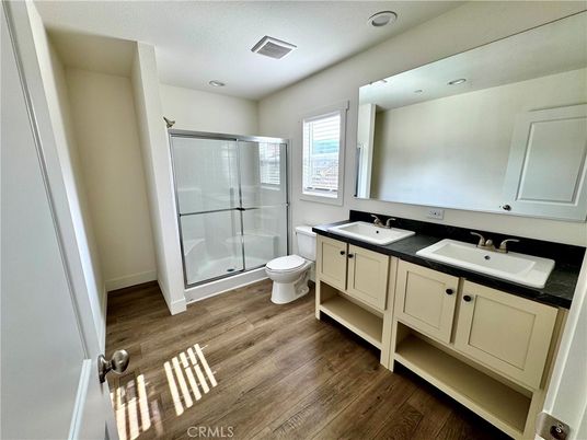 Bathroom, Dual Sink Vanities, Glass Shower, Interior, Recessed Lighting, Wood Texture Flooring