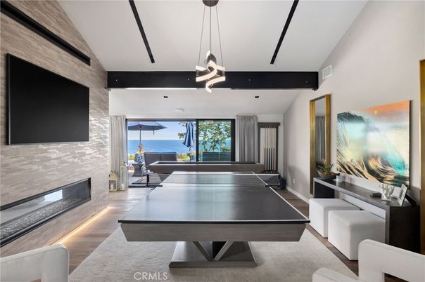 Fireplace, Game Room, Interior, Pendant Lights, Recessed Lighting, Stone Walls, Water, Wood Texture Flooring