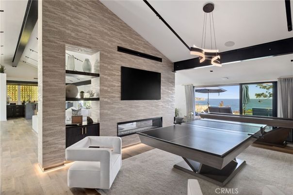 Fireplace, Game Room, Interior, Pendant Lights, Stone Walls, Water, Wood Texture Flooring