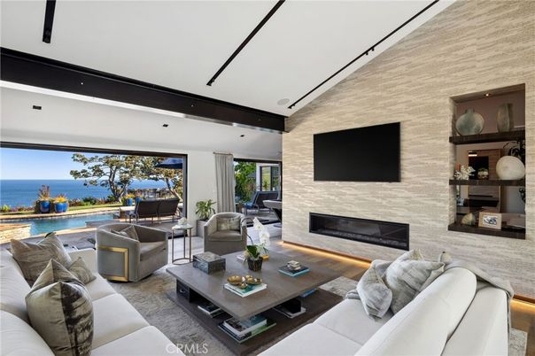 Fireplace, Interior, Living room, Recessed Lighting, Stone Walls, Water, Wood Texture Flooring