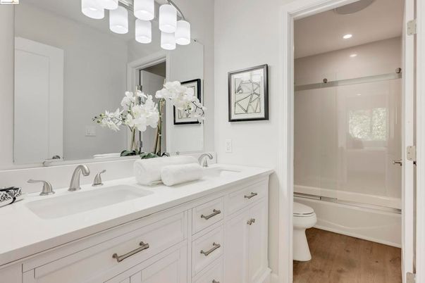 Bathroom, Dual Sink Vanities, Glass Shower, Interior, Recessed Lighting, Wood Texture Flooring