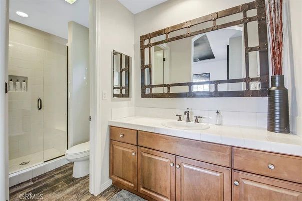 Bathroom, Glass Shower, Interior, Recessed Lighting, Tile Countertops, Wood Texture Flooring