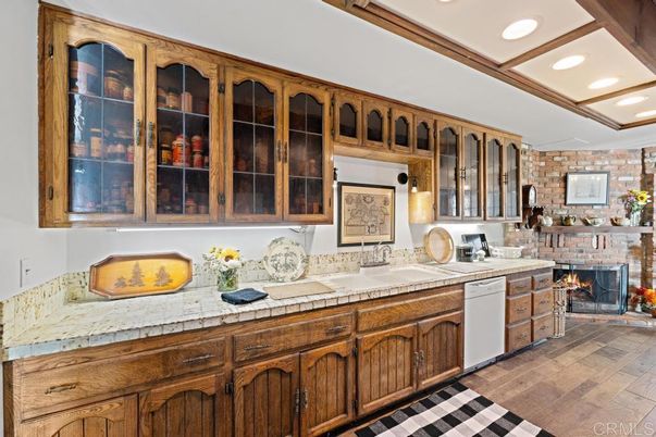 Fireplace, Interior, Kitchen, Recessed Lighting, Stone Walls, Tile Countertops, Wood Texture Flooring