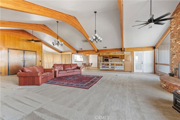Chandelier, Empty room, Fireplace, Interior, Living room, Pendant Lights, Stone Walls, Wooden Beams