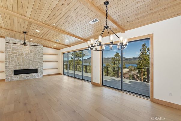 Chandelier, Empty room, Fireplace, Interior, Recessed Lighting, Stone Walls, Wooden Beams, Wooden Ceilings, Wood Texture Flooring