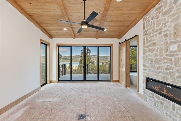 Empty room, Fireplace, Interior, Recessed Lighting, Stone Walls, Water, Wooden Beams, Wooden Ceilings