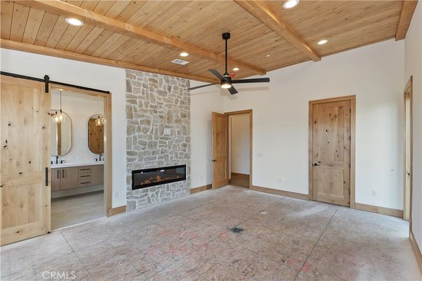 Empty room, Fireplace, Interior, Recessed Lighting, Stone Walls, Wooden Beams, Wooden Ceilings