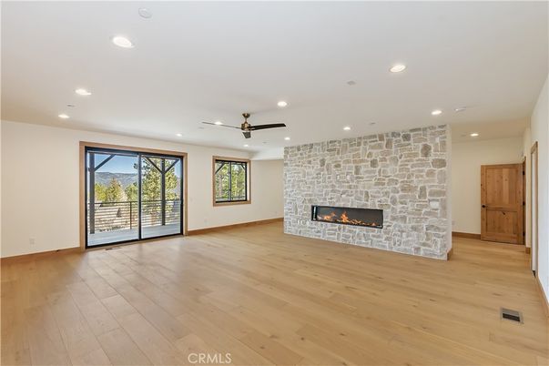Empty room, Fireplace, Interior, Recessed Lighting, Stone Walls, Wood Texture Flooring