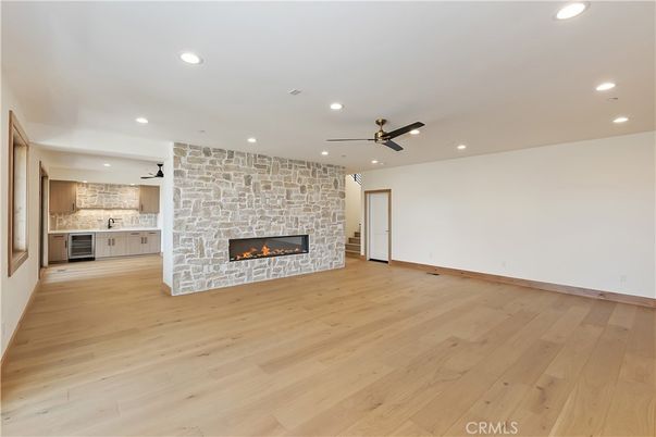 Empty room, Fireplace, Interior, Kitchen, Recessed Lighting, Stone Walls, Wood Texture Flooring
