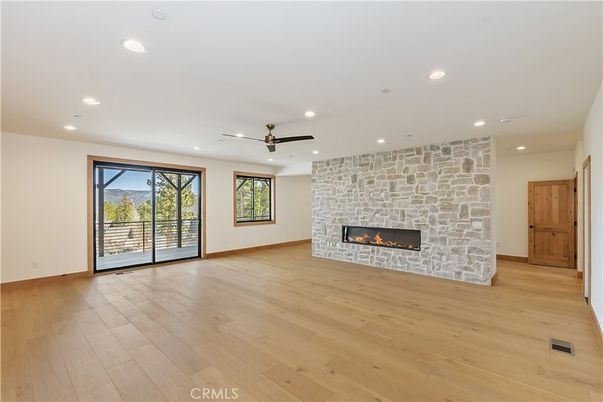 Empty room, Fireplace, Interior, Recessed Lighting, Stone Walls, Wood Texture Flooring