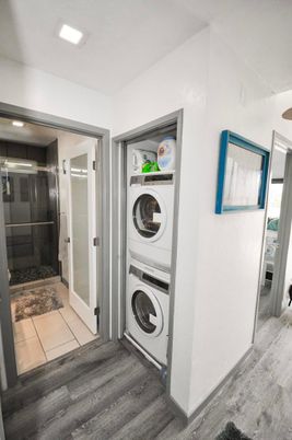 Bathroom, Glass Shower, Interior, Recessed Lighting, Utility Closets, Washer, Wood Texture Flooring