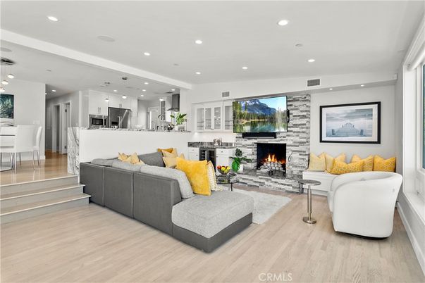 Fireplace, Interior, Kitchen, Living room, Pendant Lights, Recessed Lighting, Stainless Steel Appliances, Stone Walls, Wood Texture Flooring