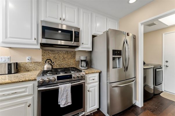 Interior, Kitchen, Recessed Lighting, Stainless Steel Appliances, Washer, Wood Texture Flooring