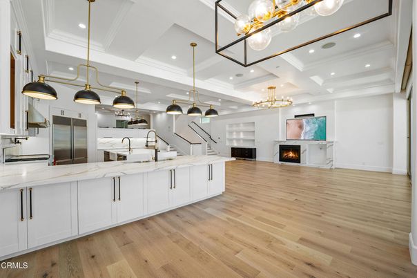 Chandelier, Fireplace, Interior, Kitchen, Pendant Lights, Recessed Lighting, Stainless Steel Appliances, Wood Texture Flooring