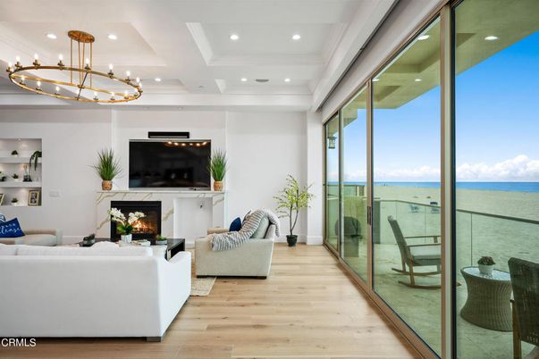 Chandelier, Fireplace, Interior, Living room, Recessed Lighting, Water, Wood Texture Flooring