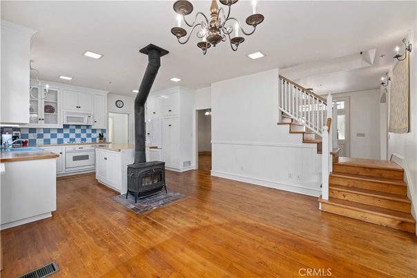 Chandelier, Fireplace, Interior, Kitchen, Recessed Lighting, Wood Texture Flooring
