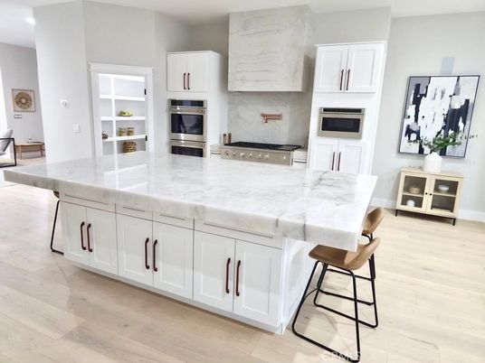 Interior, Kitchen, Marble Walls, Recessed Lighting, Stainless Steel Appliances, Wood Texture Flooring