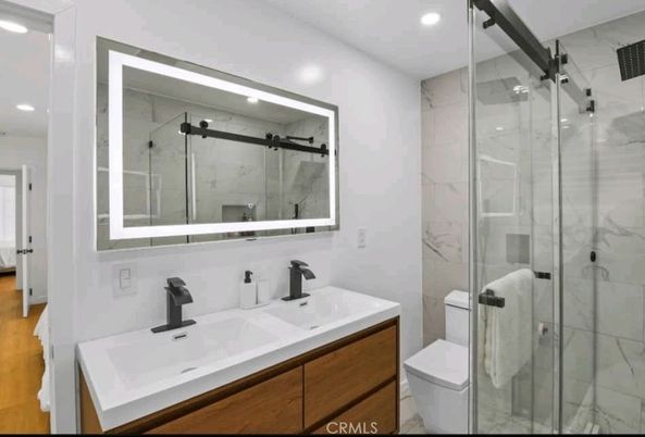 Bathroom, Dual Sink Vanities, Glass Shower, Interior, Marble Walls, Recessed Lighting, Wood Texture Flooring