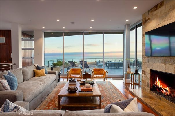 Fireplace, Interior, Living room, Recessed Lighting, Stone Walls, Water, Wood Texture Flooring