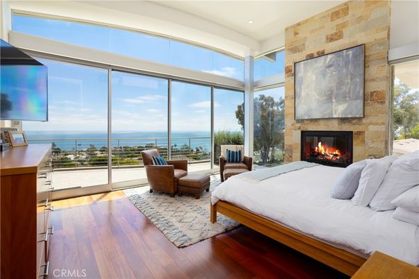 Bedroom, Fireplace, Interior, Recessed Lighting, Stone Walls, Water, Wood Texture Flooring