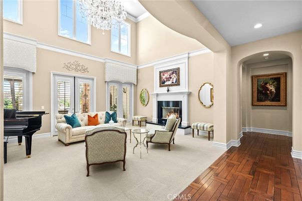 Chandelier, Fireplace, Interior, Living room, Piano, Recessed Lighting, Wood Texture Flooring