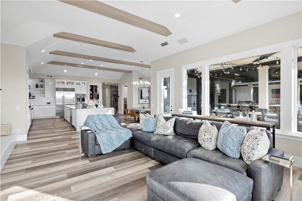 Chandelier, Dining room, Interior, Kitchen, Living room, Pendant Lights, Recessed Lighting, Stainless Steel Appliances, Wooden Beams, Wood Texture Flooring