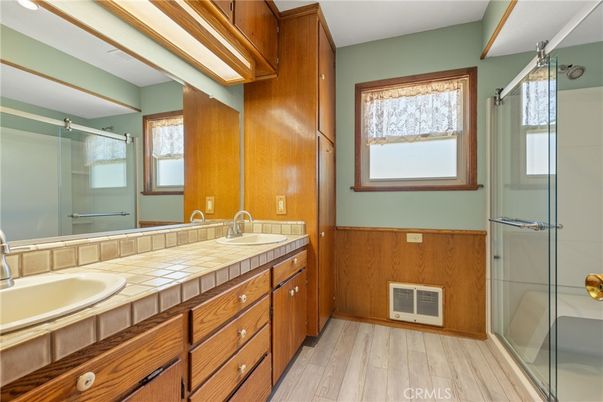 Bathroom, Dual Sink Vanities, Glass Shower, Interior, Tile Countertops, Wood Texture Flooring