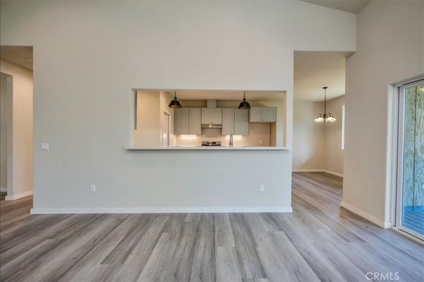 Empty room, Interior, Kitchen, Pendant Lights, Stainless Steel Appliances, Wood Texture Flooring