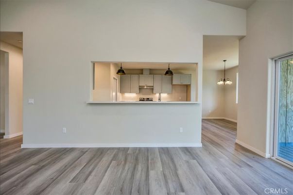 Empty room, Interior, Kitchen, Pendant Lights, Stainless Steel Appliances, Wood Texture Flooring