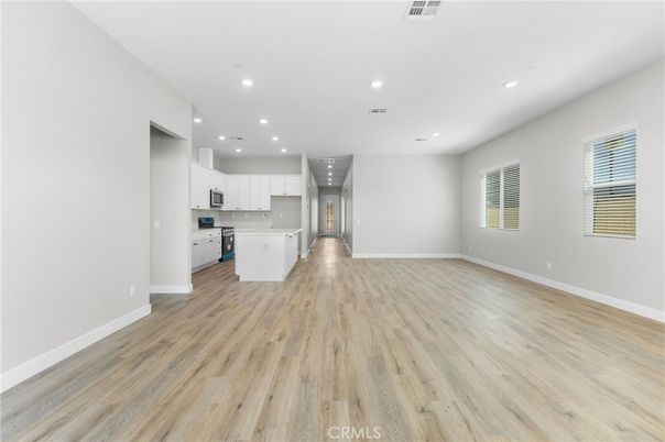 Empty room, Interior, Kitchen, Recessed Lighting, Stainless Steel Appliances, Wood Texture Flooring